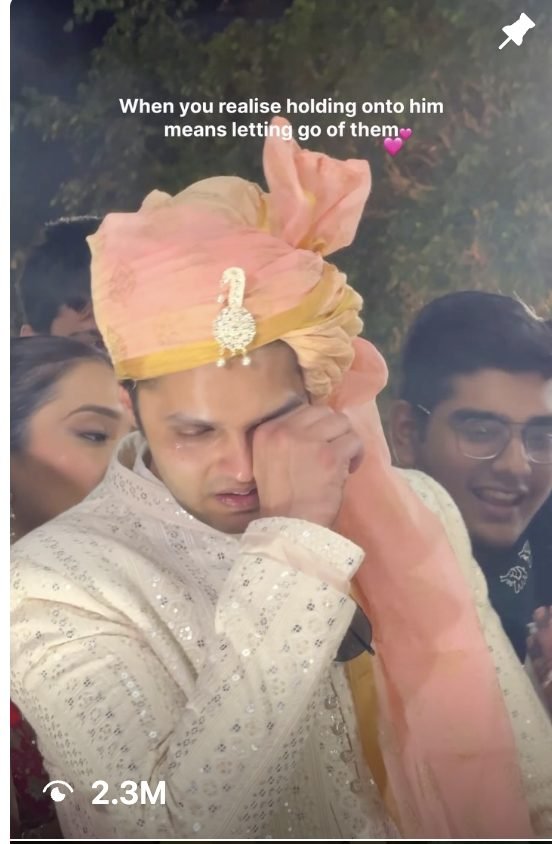 Groom wiping tears at his wedding